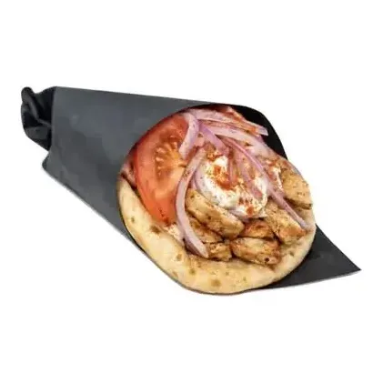 Chicken gyro pita wrapped in black paper