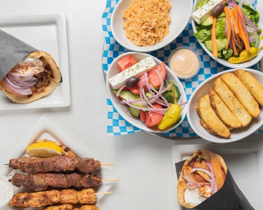 Pitas, souvlaki skewers, rice, salads and lemon potatoes to share
