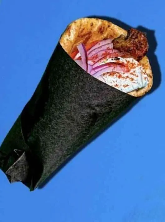 Gyro pita wrapped in black paper